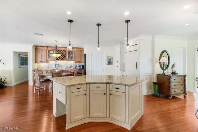 kitchen with backsplash, a center island, dark wood-style floors, glass insert cabinets, and crown molding