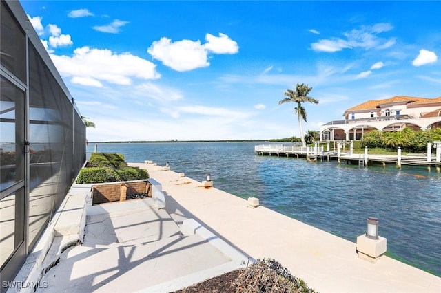 dock area with a water view and glass enclosure