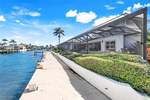 dock area with glass enclosure and a water view