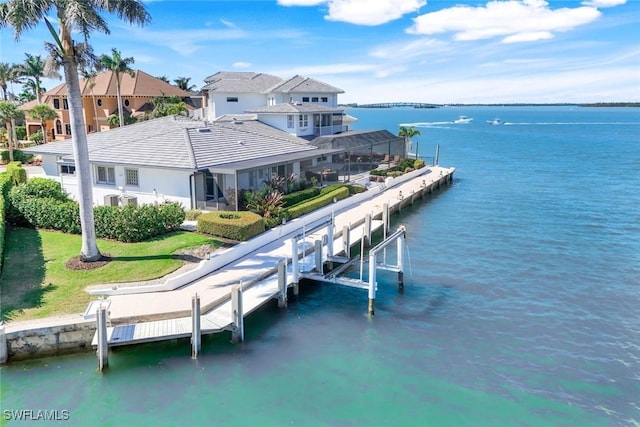 view of dock featuring glass enclosure, a water view, and boat lift