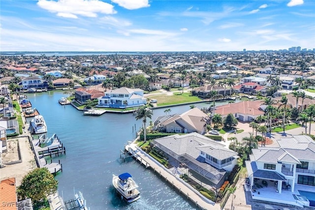 drone / aerial view with a water view and a residential view