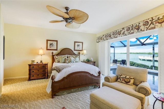 bedroom featuring baseboards, a ceiling fan, light colored carpet, a sunroom, and access to exterior