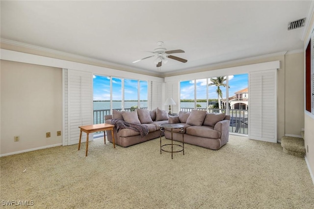 living room featuring ornamental molding, carpet flooring, visible vents, and a healthy amount of sunlight