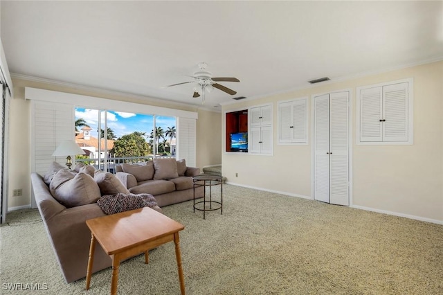 living room featuring light colored carpet, visible vents, ornamental molding, ceiling fan, and baseboards