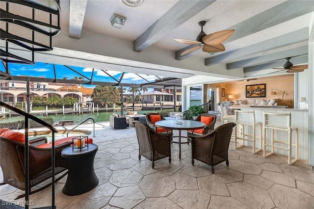 view of patio featuring outdoor dining area, a lanai, ceiling fan, and outdoor dry bar