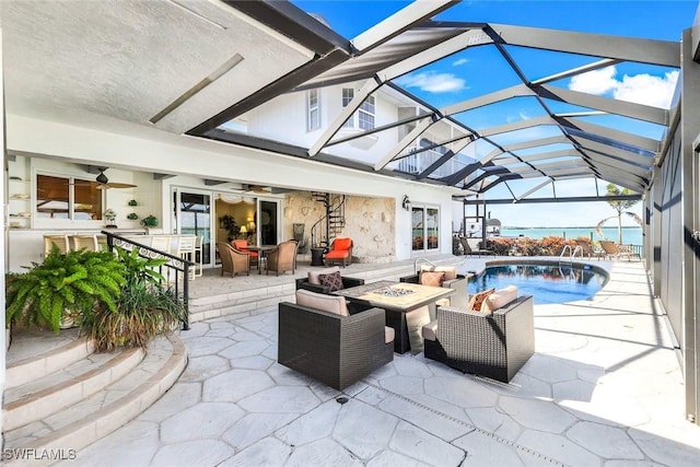 view of patio with an outdoor living space with a fire pit, a lanai, and an outdoor pool