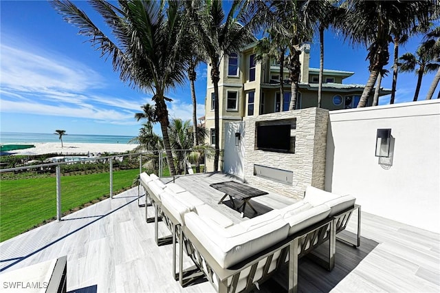 view of patio / terrace featuring a water view and a beach view