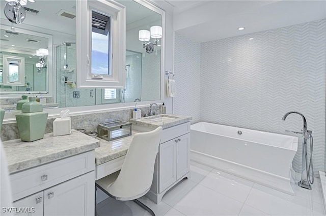 full bathroom featuring visible vents, a soaking tub, tile patterned floors, vanity, and tile walls