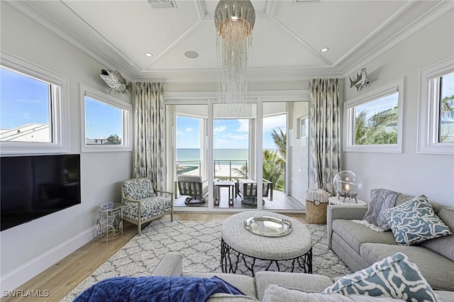 sunroom with lofted ceiling and a water view