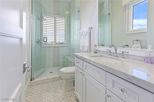 full bathroom featuring vanity, a marble finish shower, and toilet