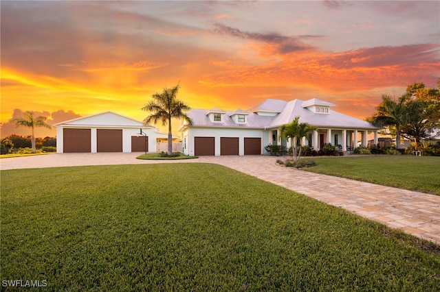 view of front of home with driveway and a lawn