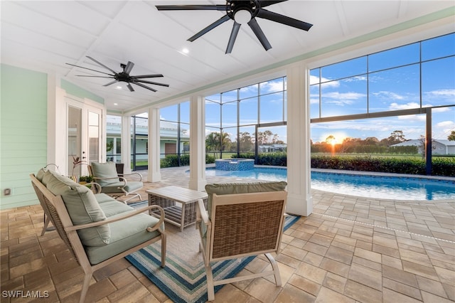 sunroom featuring ceiling fan