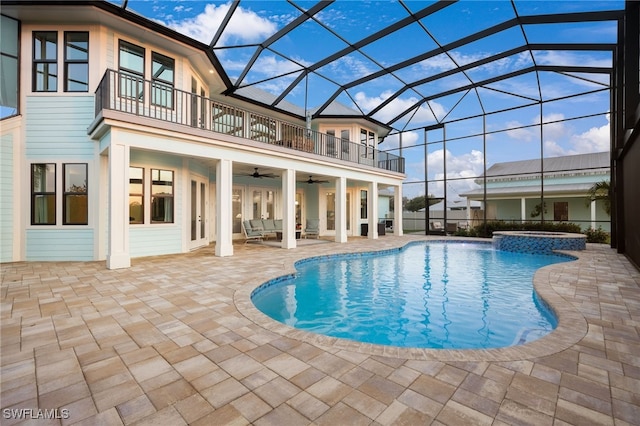 view of swimming pool with french doors, a patio, a pool with connected hot tub, ceiling fan, and a lanai