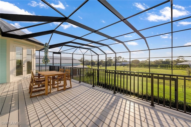 wooden terrace with glass enclosure, outdoor dining area, and a lawn