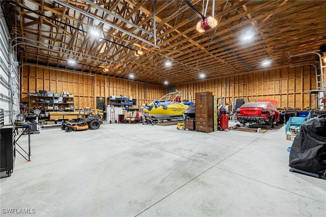 garage featuring a garage door opener and a workshop area