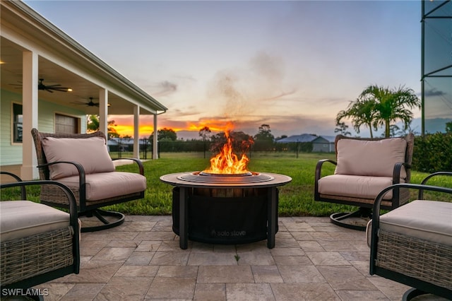 view of patio featuring a ceiling fan and a fire pit