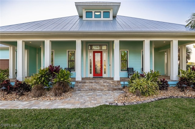 view of front facade featuring covered porch, metal roof, and a standing seam roof