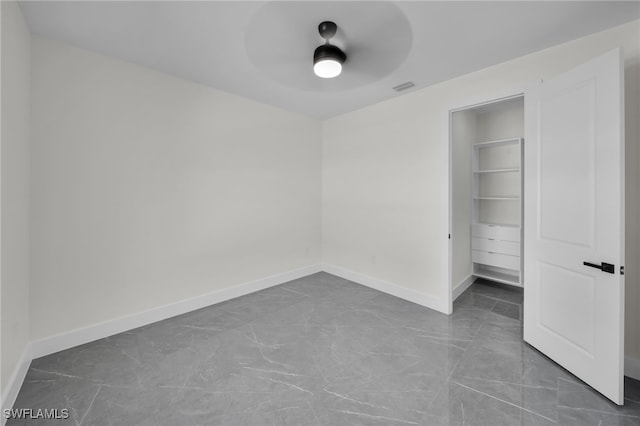 unfurnished bedroom with visible vents, ceiling fan, and baseboards