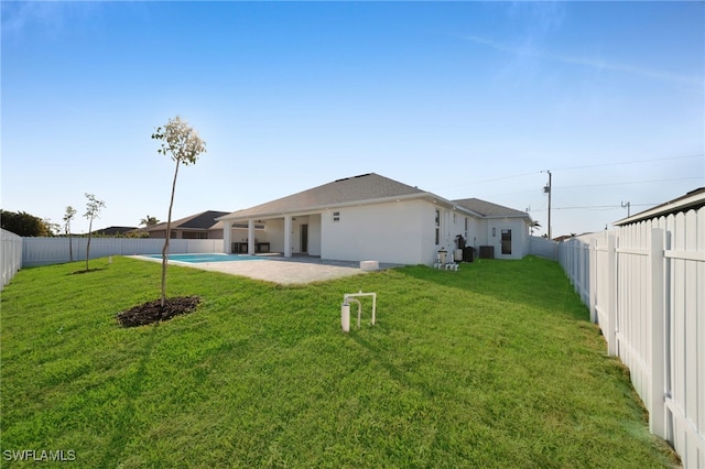 back of house with a yard, a patio, a fenced backyard, and a fenced in pool