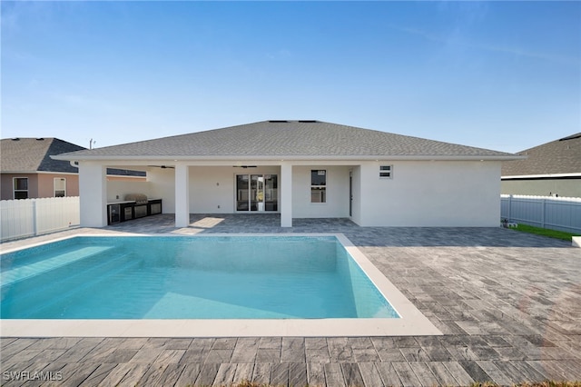 view of pool with a patio, fence, and a ceiling fan