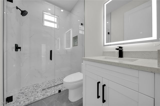 bathroom featuring toilet, marble finish floor, a marble finish shower, and vanity