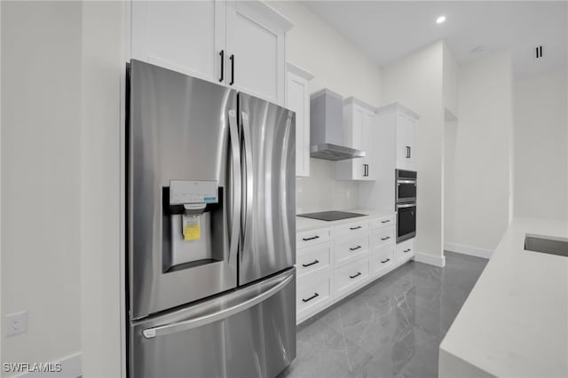 kitchen featuring marble finish floor, appliances with stainless steel finishes, wall chimney range hood, and light countertops