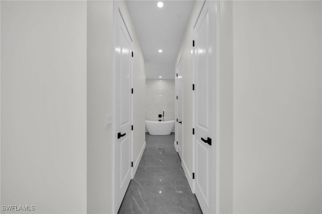 hallway with marble finish floor and recessed lighting