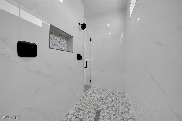 full bath with a marble finish shower