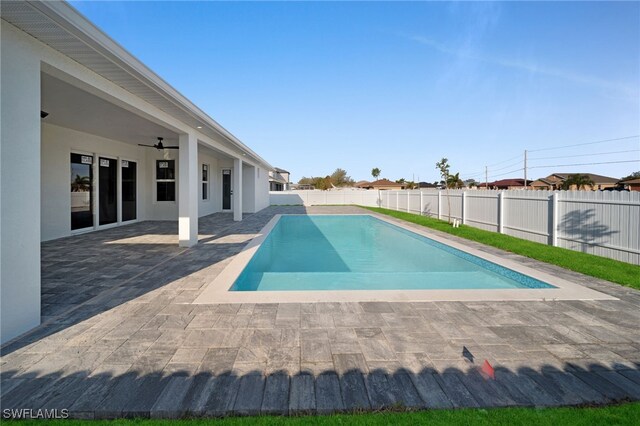 view of swimming pool featuring a ceiling fan, a patio area, a fenced backyard, and a fenced in pool