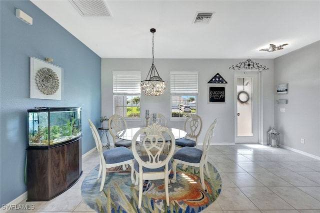 dining room with visible vents, a notable chandelier, baseboards, and light tile patterned flooring