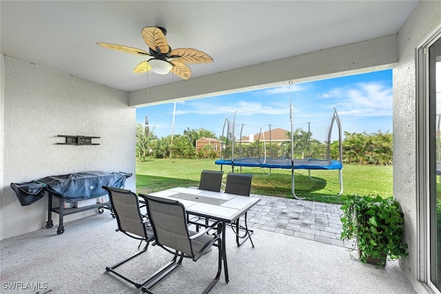 sunroom / solarium with a ceiling fan