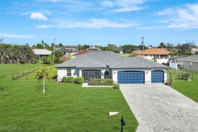 ranch-style home with a garage, decorative driveway, a front yard, and fence