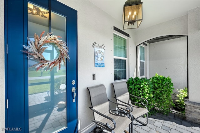 exterior space featuring a porch and stucco siding