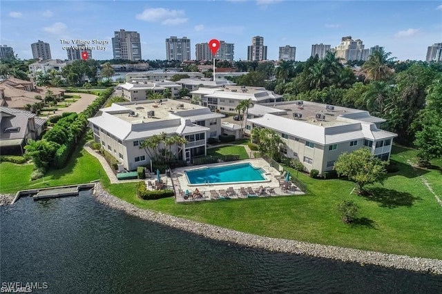 drone / aerial view featuring a water view and a view of city