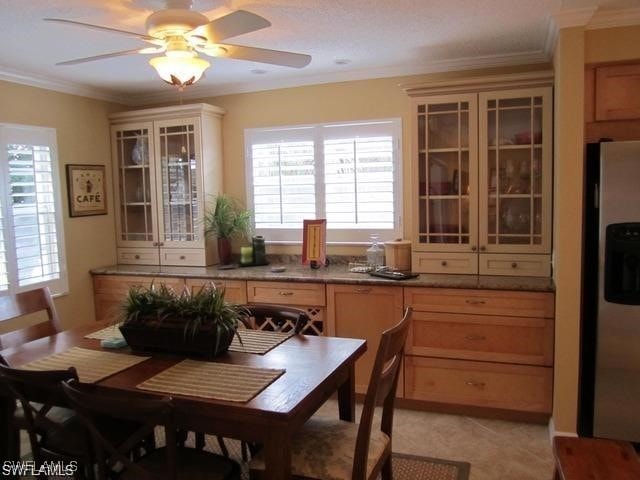 dining area with ceiling fan and ornamental molding