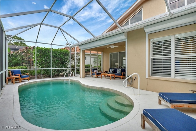 pool featuring glass enclosure, ceiling fan, and a patio area