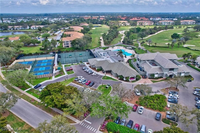 aerial view with golf course view and a water view