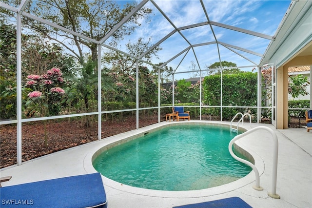 outdoor pool with a patio area and a lanai