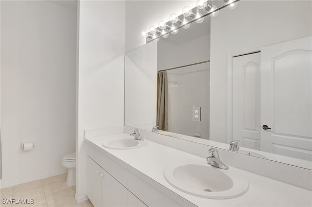 full bathroom with tile patterned flooring, curtained shower, toilet, and a sink