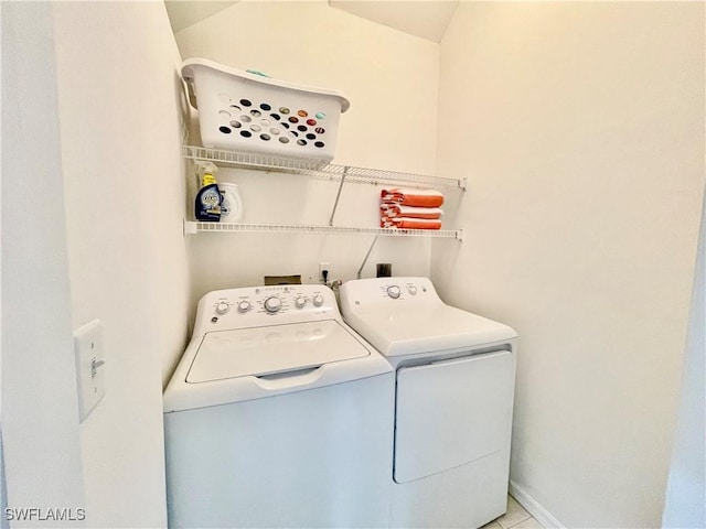 clothes washing area with washing machine and clothes dryer and laundry area