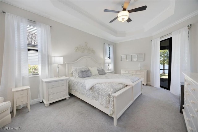 bedroom with light colored carpet, a ceiling fan, access to exterior, a raised ceiling, and crown molding