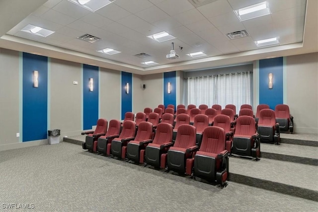 cinema featuring a paneled ceiling, baseboards, visible vents, and carpet flooring