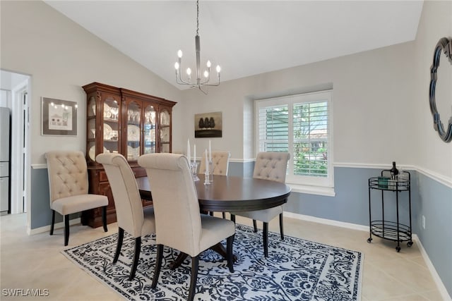 dining area featuring lofted ceiling, an inviting chandelier, light tile patterned floors, and baseboards