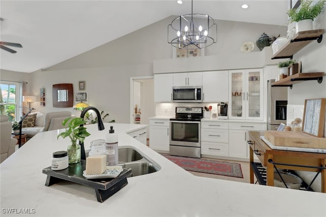 kitchen with open shelves, stainless steel appliances, a ceiling fan, white cabinets, and a sink