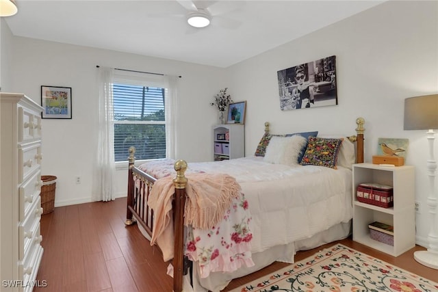 bedroom with ceiling fan, baseboards, and wood finished floors