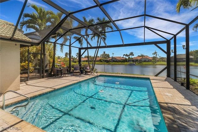 pool with a lanai, a water view, and a patio