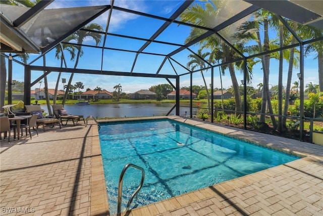 outdoor pool with a patio, a water view, and a lanai