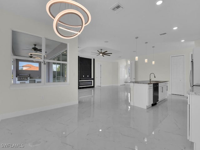 kitchen with visible vents, a sink, open floor plan, white cabinets, and dishwasher