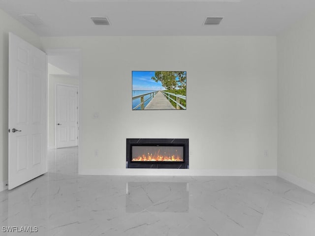 interior space with visible vents, baseboards, and a lit fireplace