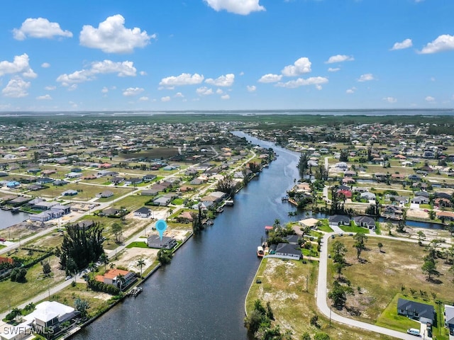 drone / aerial view featuring a residential view and a water view